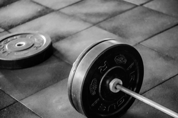 black barbell on tile flooring