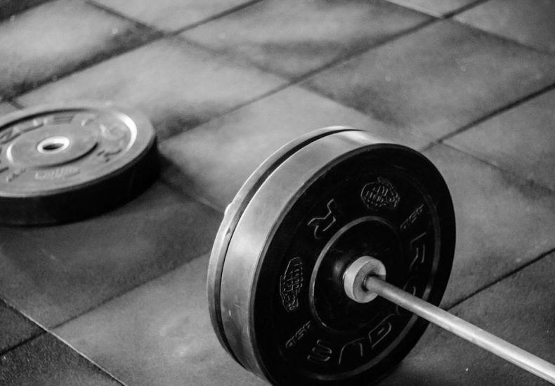 black barbell on tile flooring