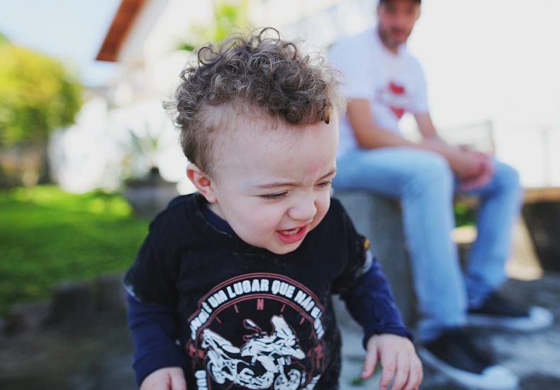 man watching toddler walking